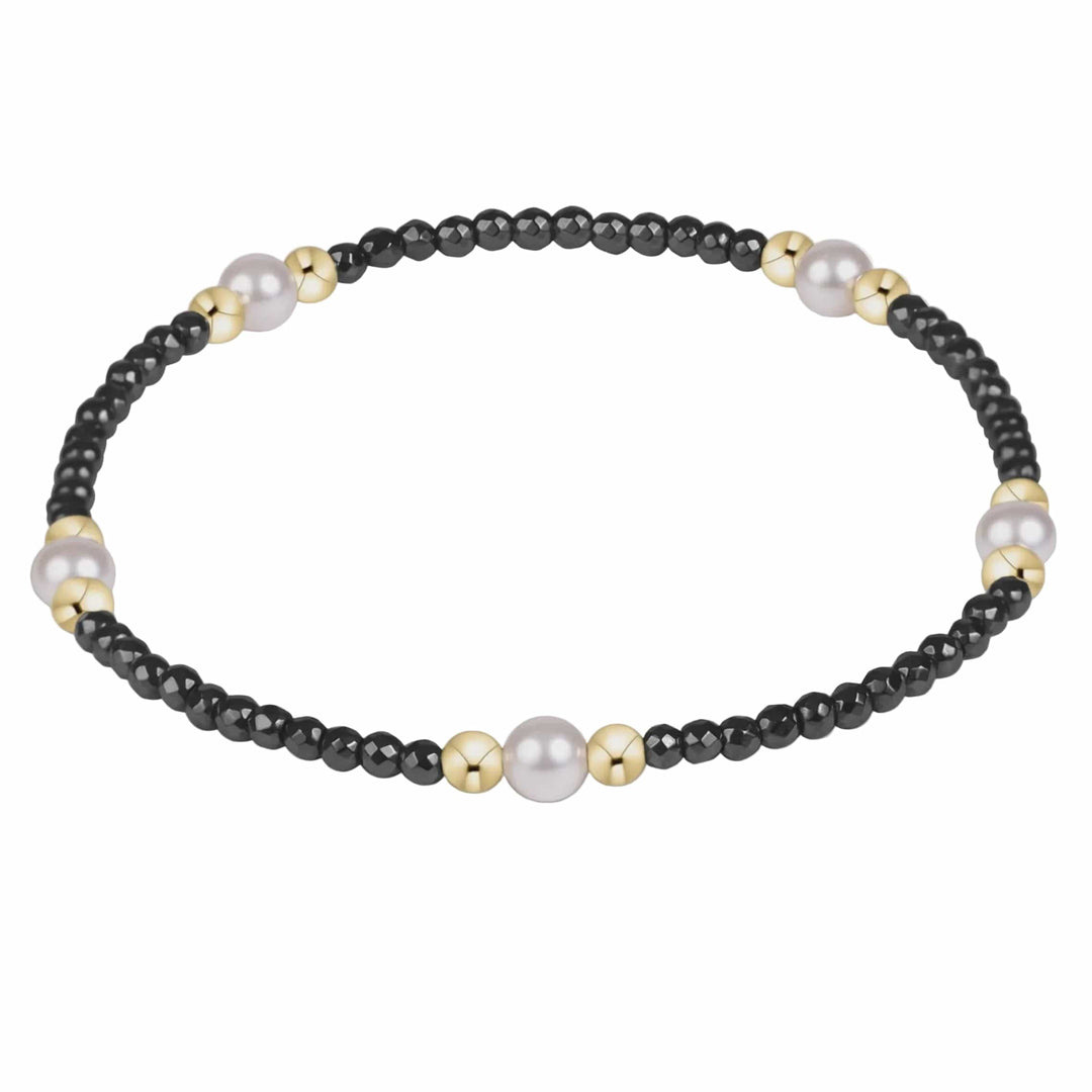 Enewton Purpose Pearl bracelet with black faceted hematite, pearl crystals, and 14kt gold-filled beads on white background