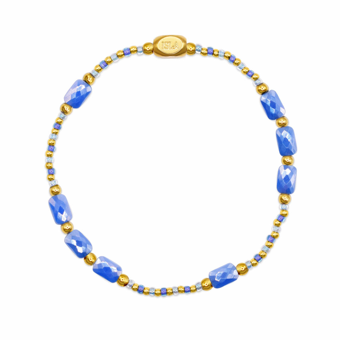 Necklace with blue beads and gold accents on a white background